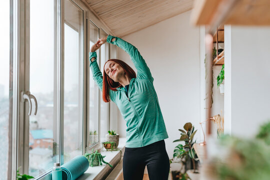 Woman doing stretching exercise at home