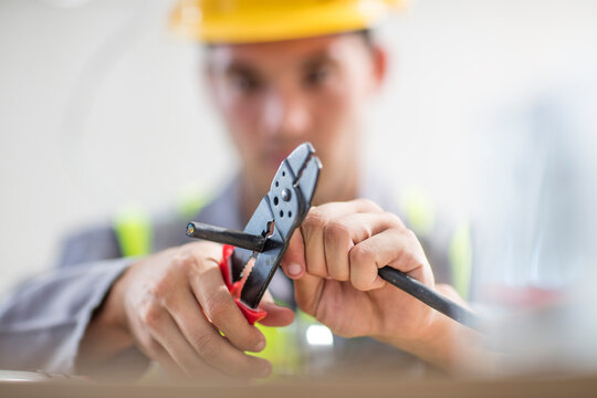 Close-up of electrician cutting wire