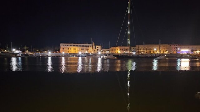 Trani city at night with beach view for text, Italy