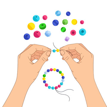 A pair of hands stringing colorful beads to create a handmade bracelet