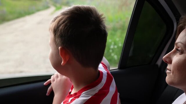 Holiday road trip with family, Little boy loves the view, Mom shares his excitement, Discovering new horizons together, Joyful moments in the car, Simple joys of being together, Nature inspires young