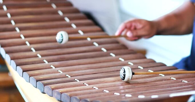 Hands playing traditional Thai xylophone (Ranat Ek), close-up. Perfect for culture, music education, performance, and traditional Thai art concepts