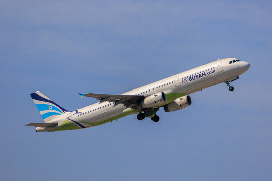 Fukuoka Japan - 2025 April 26: An Air Busan Airbus A321-200 passenger aircraft with registration HL7728 climbing into the blue sky while retracting its landing gear after takeoff from Fukuoka Airport.