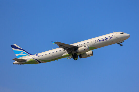 Fukuoka Japan - 2025 April 26: An Air Busan Airbus A321-200 passenger aircraft with registration HL7728 climbing into the blue sky while retracting its landing gear after takeoff from Fukuoka Airport.