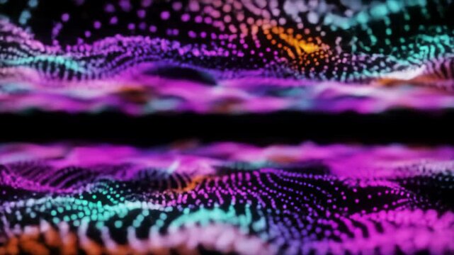 Expansive wide video captures hyper-luminous electric teal, purple, orange, pink particles swarming, merging, and flowing organically in a dark digital void, forming intricate patterns. Concept of