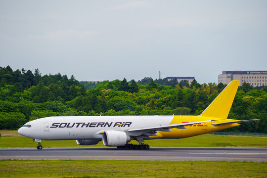Narita, Chiba Japan - 2021 May 11: A Southern Air Boeing 777F cargo freighter aircraft with registration N775SA in DHL hybrid livery taxiing on the runway at Narita International Airport.