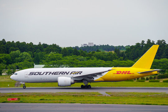 Narita, Chiba Japan - 2021 May 11: A Southern Air Boeing 777F cargo freighter aircraft with registration N775SA in DHL hybrid livery taxiing on the runway at Narita International Airport.