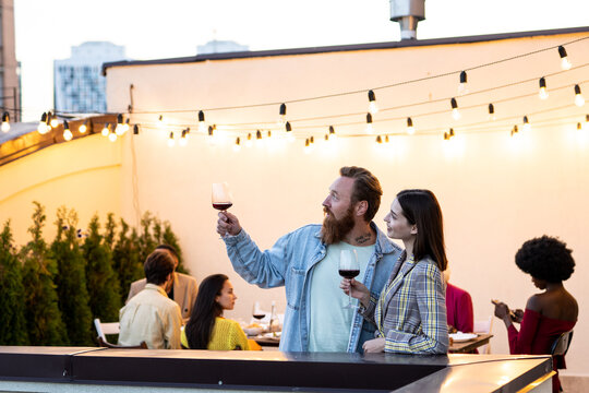 Family and friends celebrating at dinner on a rooftop terrace