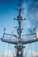 Ship structures, masts, antennas, funnel, ship wheelhouse against the blue sky and clouds. Vessel traveling at ocean. © AJITH.A