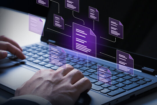Data Flow Concept: Hands typing on a laptop keyboard with glowing purple digital documents flowing out, illustrating a concept of data management or digital workflow.