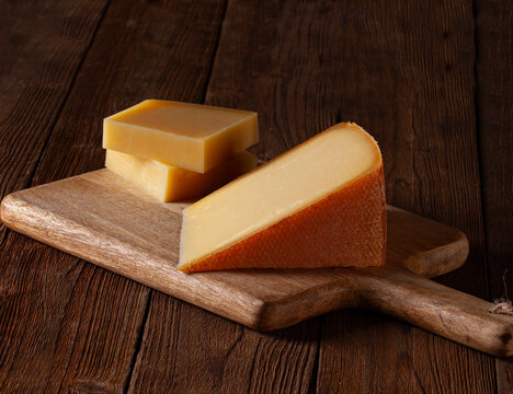Two types of Swiss cheese on rustic wood,