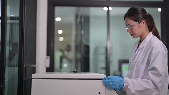 Scientist conducts experiment in laboratory while using advanced equipment for research purposes