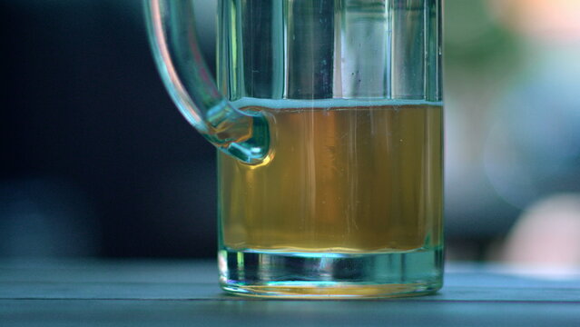 Close up of partially filled beer glass on cafe table capturing refreshment, casual social drinking and relaxed outdoor hospitality atmosphere