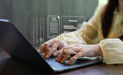 Businesswoman filing taxes online using a laptop with digital tax form interface. E-filing, tax compliance, financial documentation, online accounting, fintech services and paperless workflow. © Father_Studio
