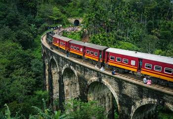 Fototapeta premium Image of the train running along the Nine Arches Bridge located in valley Demodara, Ella, Sri Lanka, Asia