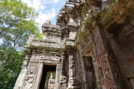Ancient stone entrance gopura gate with devata carving at Chau Say Tevoda temple Cambodia