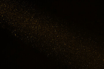 Stardust. falling shower rain corpuscular particle snow flying fallen Freeze shot on black background isolated overlay Spray water yellow golden gold dust explosion abstract powder splattered © Maxim Chuev
