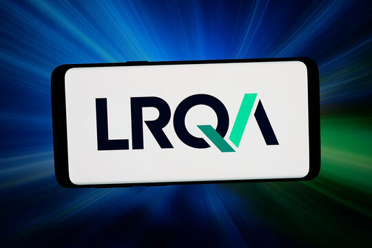 Stuttgart, Germany - 05-20-2026: In this photo illustration, the logo of British assurance company LRQA Group Limited is displayed on a smartphone in front of abstract background on computer screen.