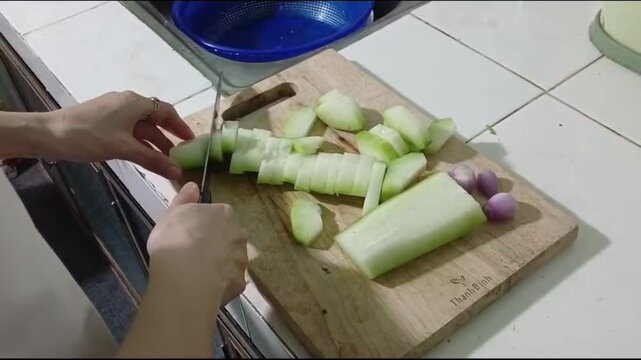 Hands Cutting Winter Melon into Small Slices for Home Cooking