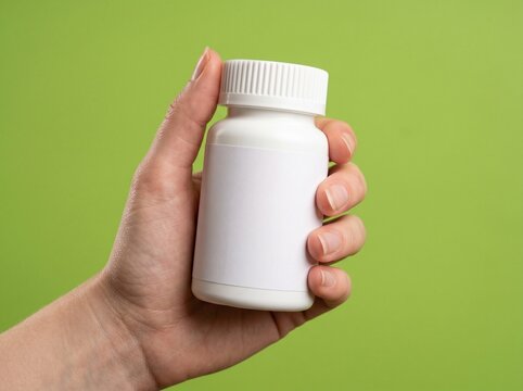 Hand Holding White Prescription Pill Bottle for Medical Treatments and Healthcare Products