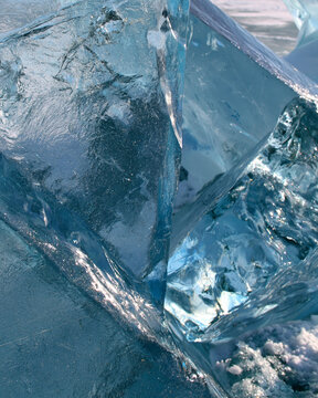 <iStock Photo of Blue Translucent Crystal Ice with Geometric Patterns and Polar Light Reflection - Nature's Frozen Beauty>