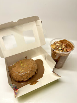 View of a chocolate-covered dessert in an open white box and a chocolate cup with toppings Beylikduzu, Istanbul, Turkiye.