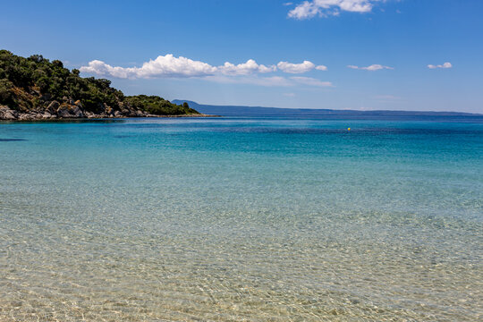 Boat that is floating in the clear water, Ammoulliani, Greece