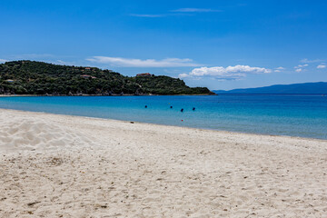 Fototapeta premium There are people on the beach in the water and in the sand, Ammoulliani, Greece