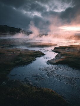 Traditional Icelandic bread steaming near a geothermal hot spring at dusk.