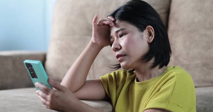 Stressed woman looking smartphone, pulling her hair, financial problems, bad news, debt daily life, social media stress, emotional breakdown, anxiety, frustration, mental pressure, intense expression