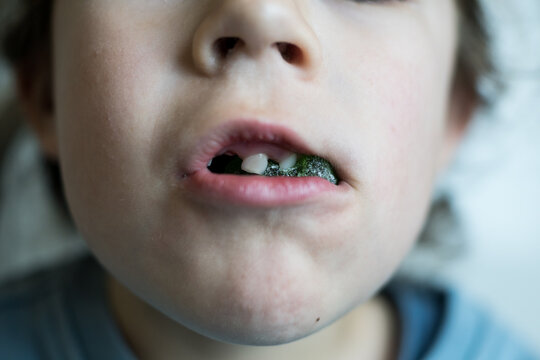 Kid Chewing Sugar Coated Green Jelly Sweet