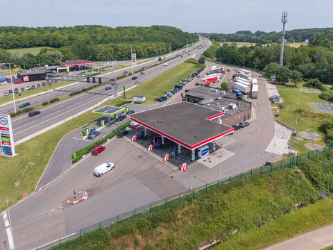 30 May 2026, Rotselaar, Belgium. Aerial drone view of highway fuel station and electric vehicle charging point along E314 motorway
