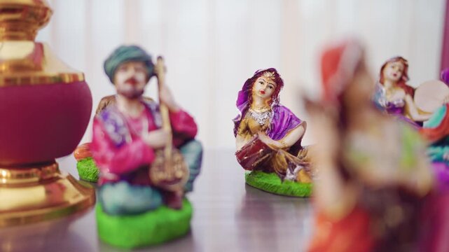 Cinematic Panning Shot of Traditional Indian Folk Musician Figurines with Bokeh Effect