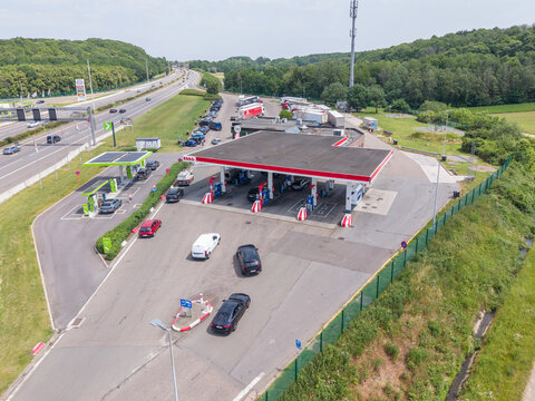 30 May 2026, Rotselaar, Belgium. Aerial drone view of highway service station with fuel pumps, EV charging and traffic flow on E314 motorway