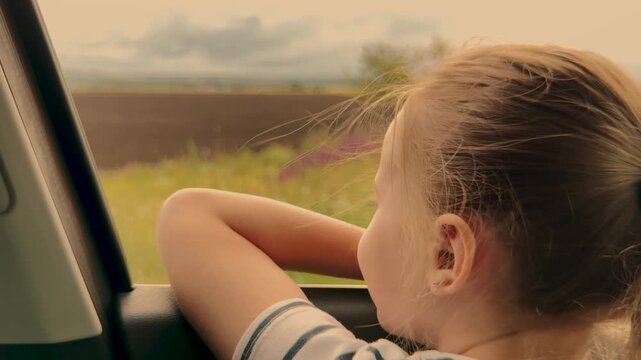 Child watching the scenery, Family vacation memories, Discovering new horizons, Wonder and curiosity, Peaceful car journeys, Simple pleasures of childhood, Adventures await beyond the glass, Soft warm