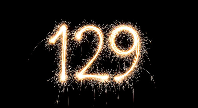 Vibrant sparkler effect forming the number 129 on a black backdrop, creating a striking visual contrast for celebrations or milestones.