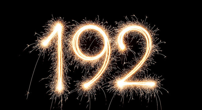 Vibrant sparkler formation spelling out the year 1992 against a dark background, evoking celebration and nostalgia.