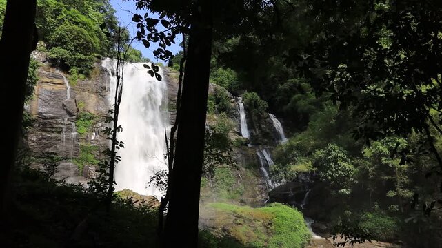 The natural video background of water flowing from high mountains, amidst various forests. The beauty of natural waterfalls is a habitat for various animals. It is worth preserving.