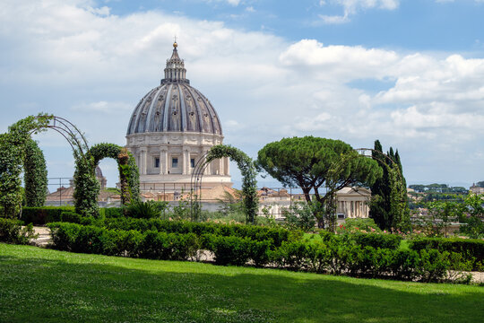 St. Peter's Basilica Dome Viewed from the Lush Green Vatican Gardens in Rome, Italy