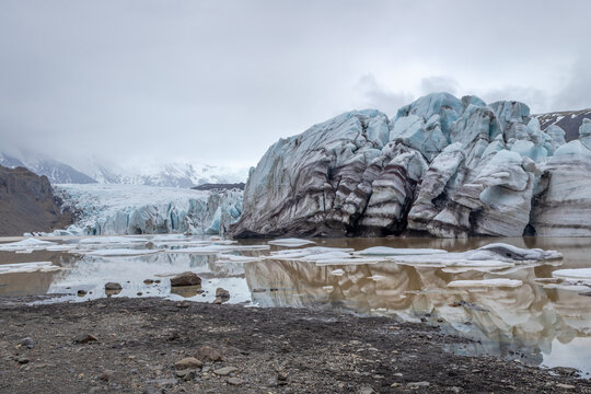A big wall of ice at the end of a glacier