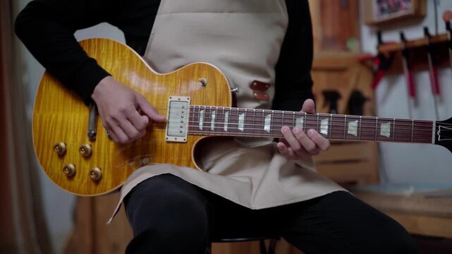 Professional Guitar Technician Testing Electric Guitar with Solo Performance After Setup
