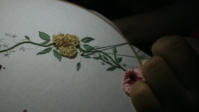 Slow motion video of someone doing the embroidery process which requires extra precision to form the pattern into a neat work.