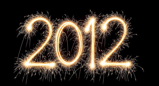 Dramatic firework sparklers forming the year 2012, glowing brightly against a dark backdrop for a festive and celebratory effect.