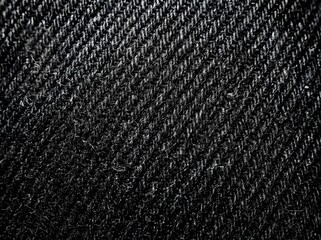 Close-up abstract dark fabric texture with diagonal woven pattern and subtle sheen in dim lighting © Choyan