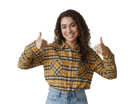 Young woman smiling and giving thumbs up wearing a plaid shirt and jeans