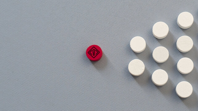 Conceptual image featuring a warning symbol positioned apart from a workforce group, representing organisational risks, workforce challenges and emerging threats.