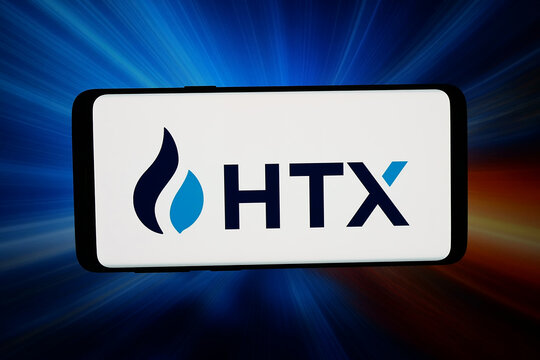 Stuttgart, Germany - 05-20-2026: In this photo illustration, the logo of cryptocurrency exchange company HTX is displayed on a smartphone in front of abstract background on computer screen.