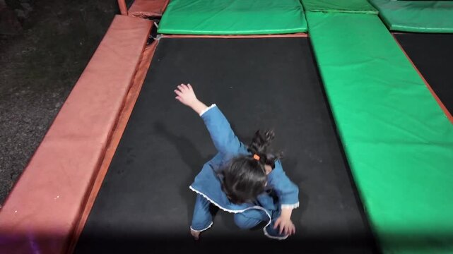 Cute little girl enjoying trampoline fun at Swat Funland Park.