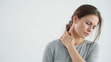 Fototapeta premium Woman with neck pain touching her neck area carefully