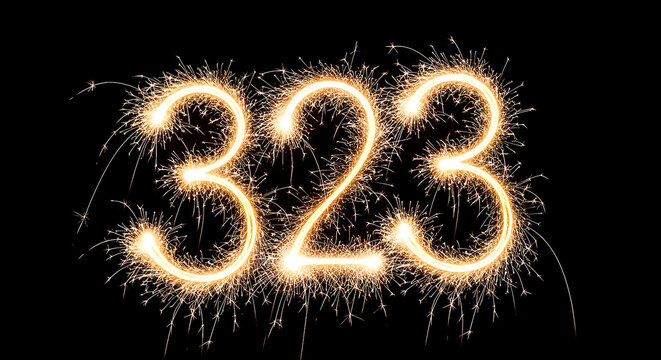 Vibrant sparkler arrangement forming the year 323 against a dark background, evoking celebration and festivity.